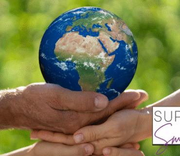 Image of hands holding up a small planet earth to demonstrate sustainability and eco-friendly living