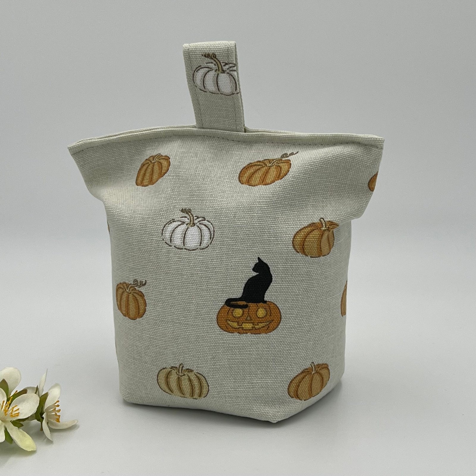Image of a door stop made with pumpkin patterned material.