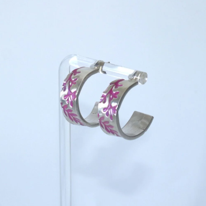 Silver hoop earrings featuring purple floral detail